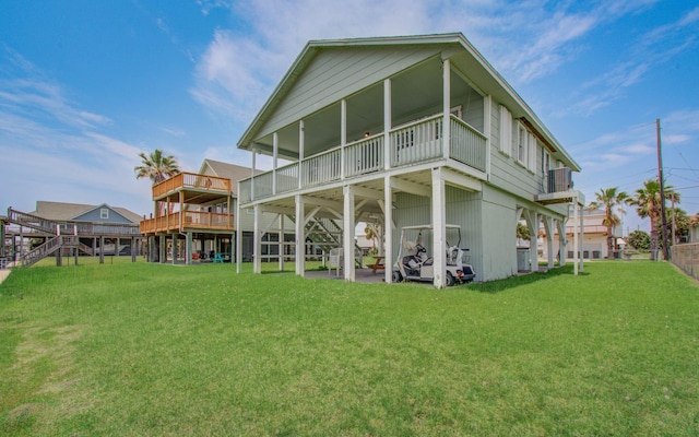 21735 Matagorda Dr, Galveston, TX 77554 - rear view of property with a yard, a deck, and stairway