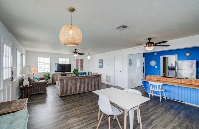 21735 Matagorda Dr, Galveston, TX 77554 - living room featuring a ceiling fan, dark wood-style flooring, and a textured ceiling