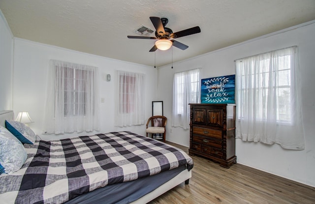 21735 Matagorda Dr, Galveston, TX 77554 - bedroom with wood finished floors, ceiling fan, and crown molding