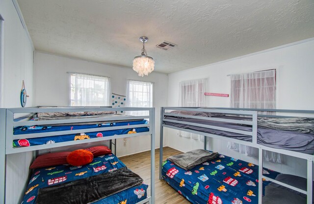 21735 Matagorda Dr, Galveston, TX 77554 - bedroom with wood finished floors and a textured ceiling