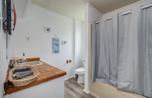21735 Matagorda Dr, Galveston, TX 77554 - full bathroom featuring toilet, wood finished floors, shower / tub combo, vanity, and ornamental molding