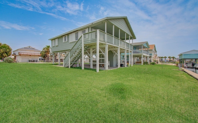 21735 Matagorda Dr, Galveston, TX 77554 - back of house with a yard, stairway, and a wooden deck