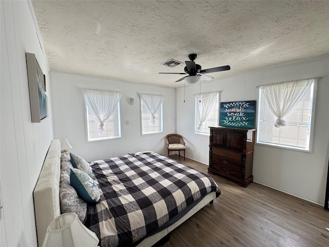 21735 Matagorda Dr, Galveston, TX 77554 - bedroom with a textured ceiling, wood finished floors, and ceiling fan