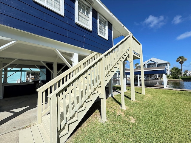 21735 Matagorda Dr, Galveston, TX 77554 - view of side of property featuring a yard, a water view, and stairway