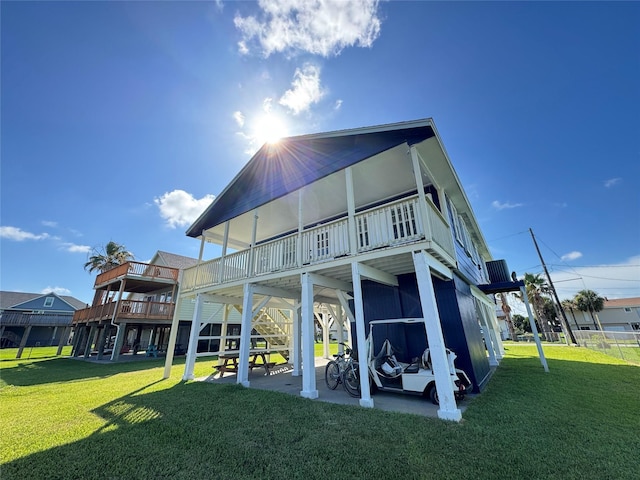 21735 Matagorda Dr, Galveston, TX 77554 - rear view of house with a lawn, stairs, and a wooden deck