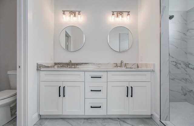 25814 Bay Breeze Dr, Galveston, TX 77554 - bathroom featuring marble look tiles, toilet, double vanity, and a marble finish shower
