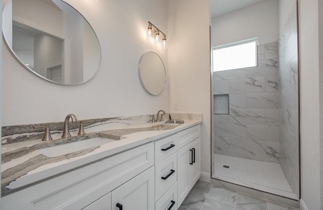 25814 Bay Breeze Dr, Galveston, TX 77554 - full bathroom with marble finish flooring, double vanity, a marble finish shower, and baseboards