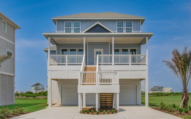 25814 Bay Breeze Dr, Galveston, TX 77554 - beach home with stairs, covered porch, an attached garage, board and batten siding, and driveway