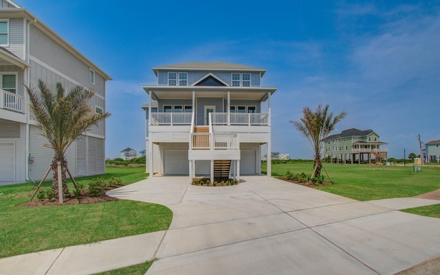 25814 Bay Breeze Dr, Galveston, TX 77554 - beach home featuring concrete driveway, a front yard, covered porch, an attached garage, and stairway