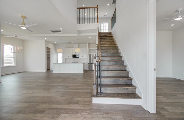 25814 Bay Breeze Dr, Galveston, TX 77554 - stairway with ceiling fan, baseboards, wood finished floors, and recessed lighting