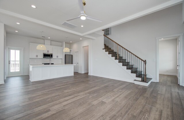 25814 Bay Breeze Dr, Galveston, TX 77554 - unfurnished living room featuring dark wood finished floors, ceiling fan, stairs, recessed lighting, and baseboards