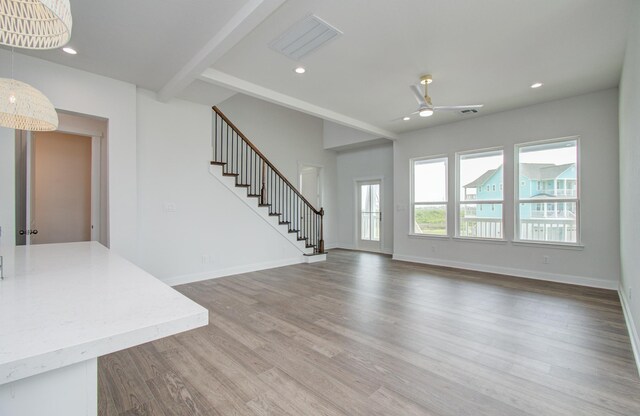 25814 Bay Breeze Dr, Galveston, TX 77554 - unfurnished living room featuring ceiling fan, stairs, beamed ceiling, wood finished floors, and recessed lighting