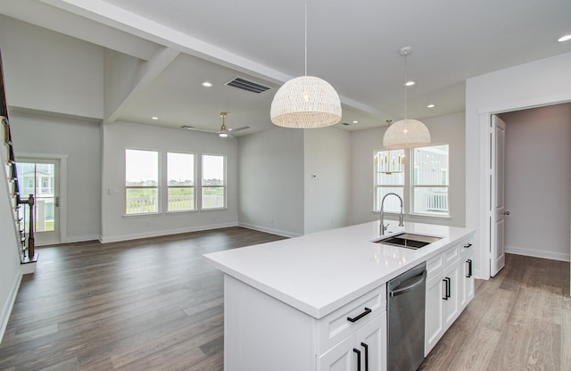 25814 Bay Breeze Dr, Galveston, TX 77554 - kitchen featuring a sink, dishwasher, wood finished floors, hanging light fixtures, and white cabinets