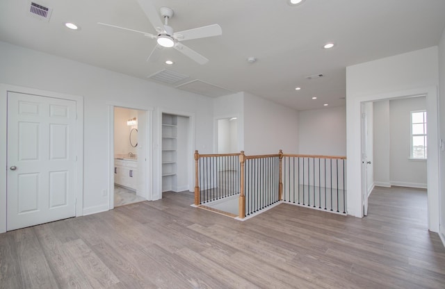 25814 Bay Breeze Dr, Galveston, TX 77554 - empty room with light wood-type flooring, built in features, recessed lighting, baseboards, and ceiling fan