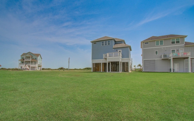25814 Bay Breeze Dr, Galveston, TX 77554 - back of house with a lawn and a balcony