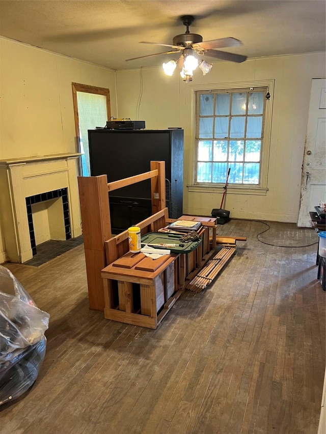 5420 Pease St, Houston, TX 77023 - living area with wood-type flooring, a ceiling fan, and a fireplace with flush hearth