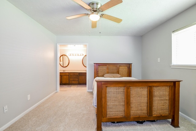 25635 Glen Loch Dr, Spring, TX 77380 - bedroom with light carpet, baseboards, connected bathroom, and ceiling fan