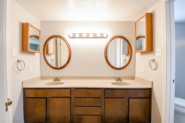 25635 Glen Loch Dr, Spring, TX 77380 - full bathroom featuring double vanity and toilet