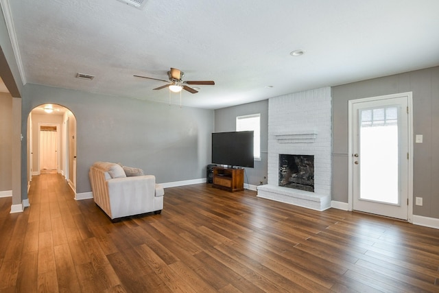 25635 Glen Loch Dr, Spring, TX 77380 - unfurnished living room with arched walkways, wood finished floors, ceiling fan, and plenty of natural light