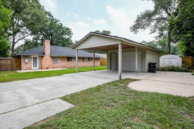 25635 Glen Loch Dr, Spring, TX 77380 - view of front of home featuring a chimney, a detached garage, brick siding, and roof with shingles