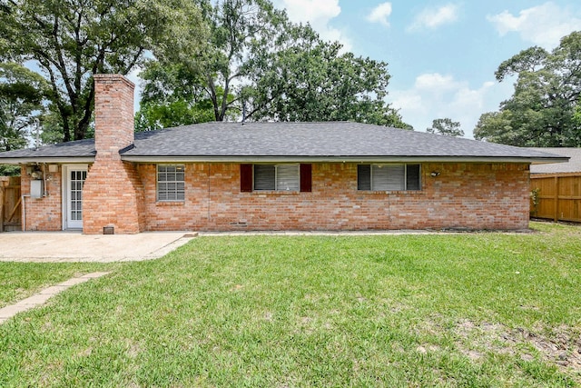 25635 Glen Loch Dr, Spring, TX 77380 - rear view of property featuring a chimney, brick siding, a patio area, and a shingled roof