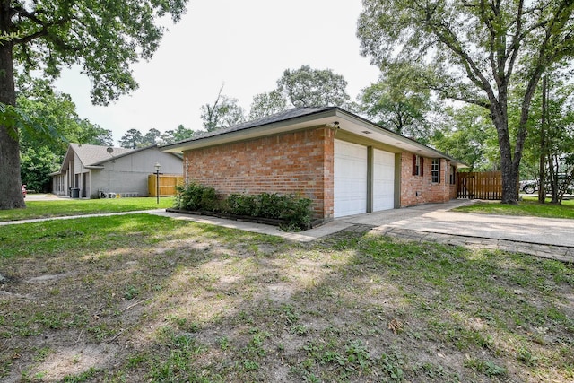 25635 Glen Loch Dr, Spring, TX 77380 - view of side of property featuring brick siding, an attached garage, and concrete driveway