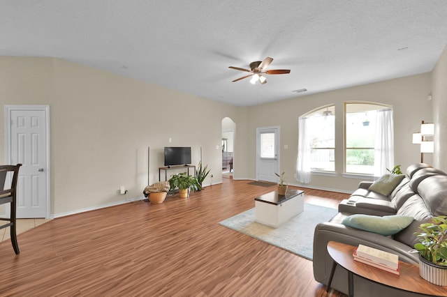 3307 Ellscott Ct, Spring, TX 77386 - living area with arched walkways, a ceiling fan, wood finished floors, and baseboards