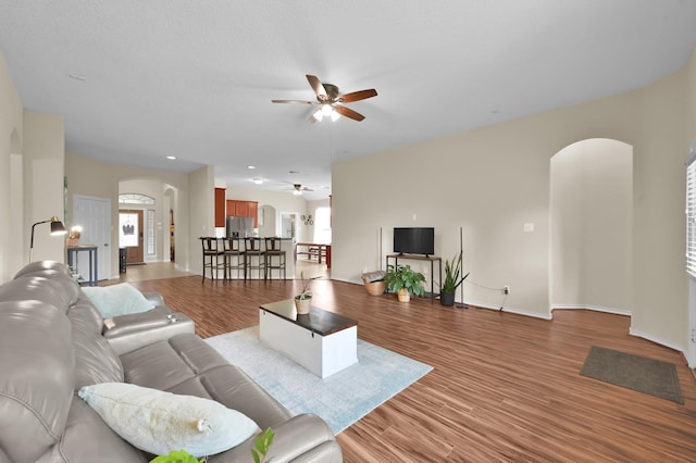 3307 Ellscott Ct, Spring, TX 77386 - living area with arched walkways, a ceiling fan, and baseboards