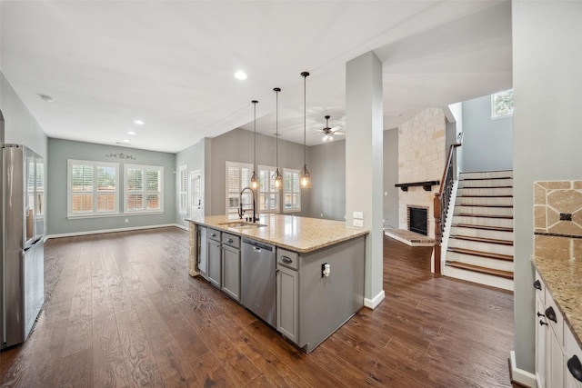 2935 Red Maple Dr, Katy, TX 77494 - kitchen with stainless steel appliances, open floor plan, gray cabinets, a sink, and recessed lighting