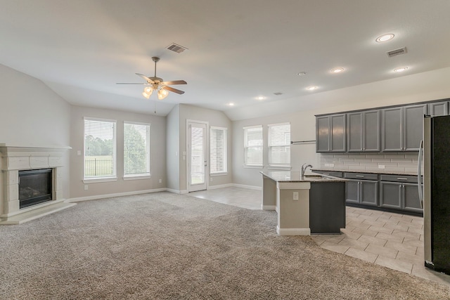 13605 Northline Lake Dr, Houston, TX 77044 - kitchen featuring freestanding refrigerator, ceiling fan, a sink, light colored carpet, and open floor plan