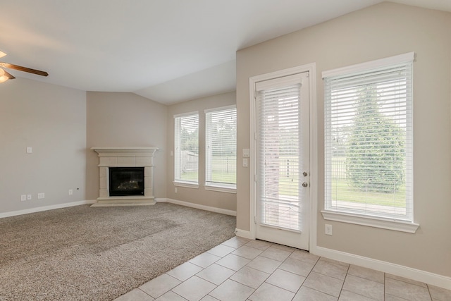 13605 Northline Lake Dr, Houston, TX 77044 - unfurnished living room featuring lofted ceiling, ceiling fan, a tiled fireplace, light tile patterned floors, and baseboards