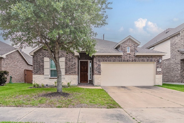 13605 Northline Lake Dr, Houston, TX 77044 - view of front of home with brick siding, an attached garage, concrete driveway, roof with shingles, and stone siding