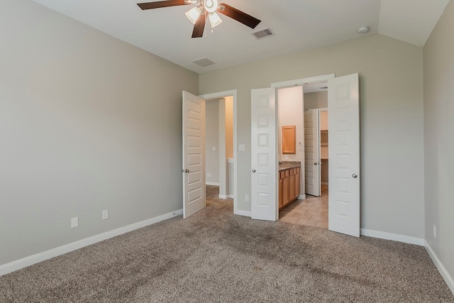 13605 Northline Lake Dr, Houston, TX 77044 - unfurnished bedroom featuring light colored carpet, baseboards, ceiling fan, ensuite bath, and lofted ceiling