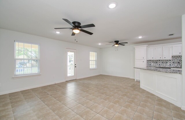 5403 Farley Dr, Houston, TX 77032 - unfurnished living room with a ceiling fan, recessed lighting, light tile patterned floors, and baseboards