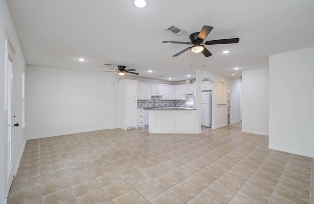 5403 Farley Dr, Houston, TX 77032 - unfurnished living room with ceiling fan, recessed lighting, baseboards, arched walkways, and light tile patterned floors