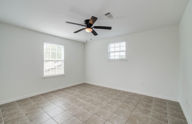 5403 Farley Dr, Houston, TX 77032 - empty room with light tile patterned floors, ceiling fan, and baseboards