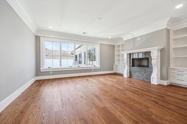 2216 Tangley St, Houston, TX 77005 - unfurnished living room with crown molding, baseboards, wood finished floors, a premium fireplace, and built in features