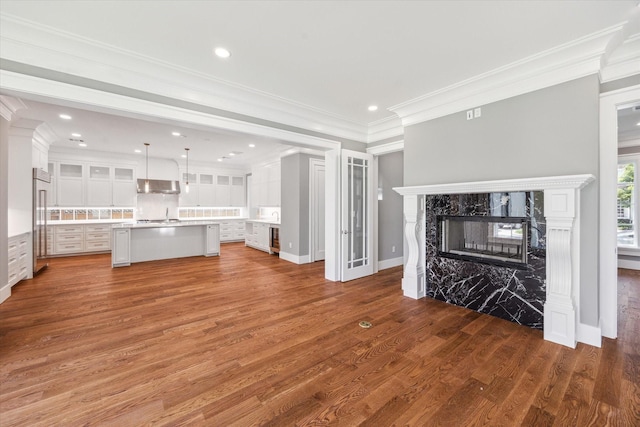2216 Tangley St, Houston, TX 77005 - unfurnished living room with crown molding, wood finished floors, a fireplace, recessed lighting, and baseboards