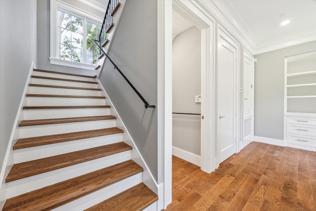 2216 Tangley St, Houston, TX 77005 - stairway featuring crown molding, wood finished floors, and baseboards