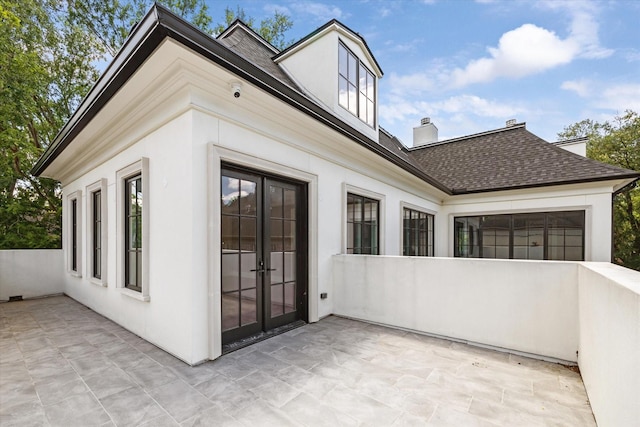 2216 Tangley St, Houston, TX 77005 - view of home's exterior with a patio area, french doors, a shingled roof, and stucco siding