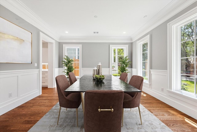 2216 Tangley St, Houston, TX 77005 - dining space with plenty of natural light, crown molding, wood finished floors, a wainscoted wall, and a decorative wall
