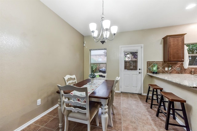 1703 Balsam Spruce Cir, Conroe, TX 77301 - dining room featuring a chandelier, tile patterned flooring, and baseboards