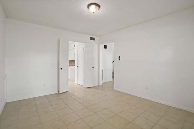31111 Alice Ln, Tomball, TX 77375 - empty room with baseboards and a textured ceiling