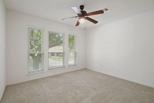 31111 Alice Ln, Tomball, TX 77375 - spare room featuring light carpet, a ceiling fan, and baseboards