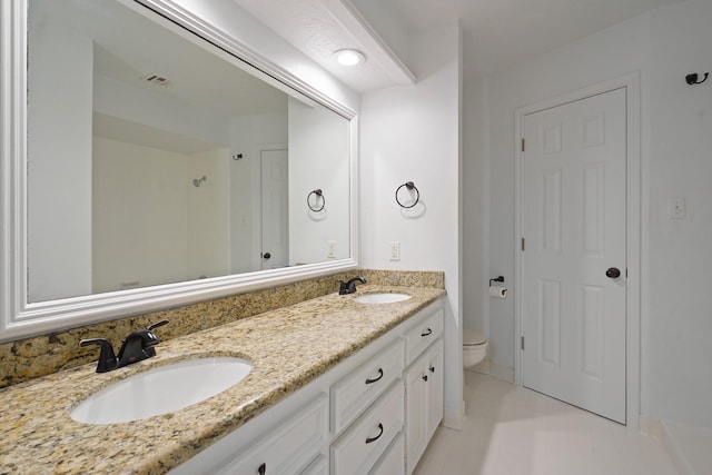 31111 Alice Ln, Tomball, TX 77375 - bathroom with double vanity, toilet, and tile patterned floors