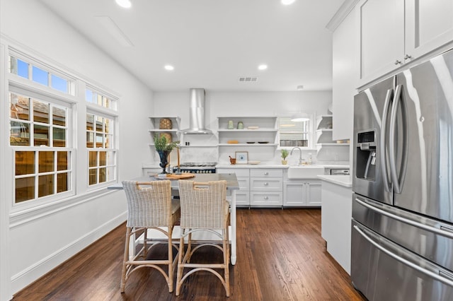 304 Bayland Ave, Houston, TX 77009 - kitchen with stainless steel refrigerator with ice dispenser, open shelves, wall chimney exhaust hood, a sink, and stove
