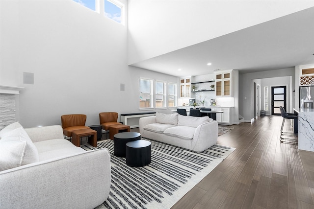 15838 Weston Ridge Dr, Humble, TX 77346 - living area featuring healthy amount of natural light, dark wood finished floors, a stone fireplace, a towering ceiling, and recessed lighting