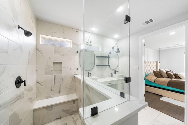 15838 Weston Ridge Dr, Humble, TX 77346 - bathroom with a tile shower, double vanity, and ensuite bath