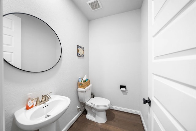 15838 Weston Ridge Dr, Humble, TX 77346 - bathroom with toilet, wood finished floors, a sink, and baseboards