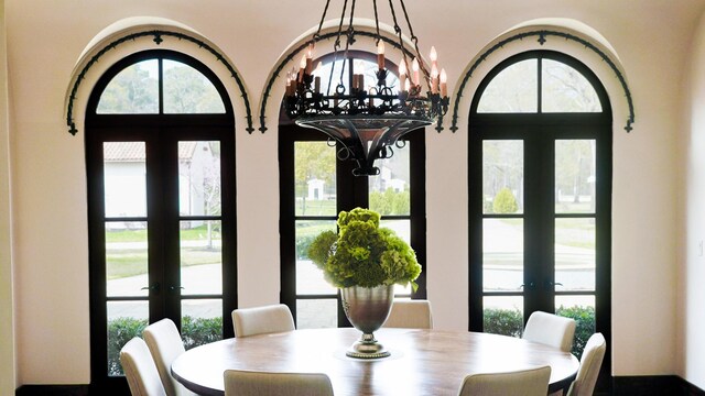 7519 Red Bay Cir, Magnolia, TX 77354 - dining area with french doors, a chandelier, and healthy amount of natural light